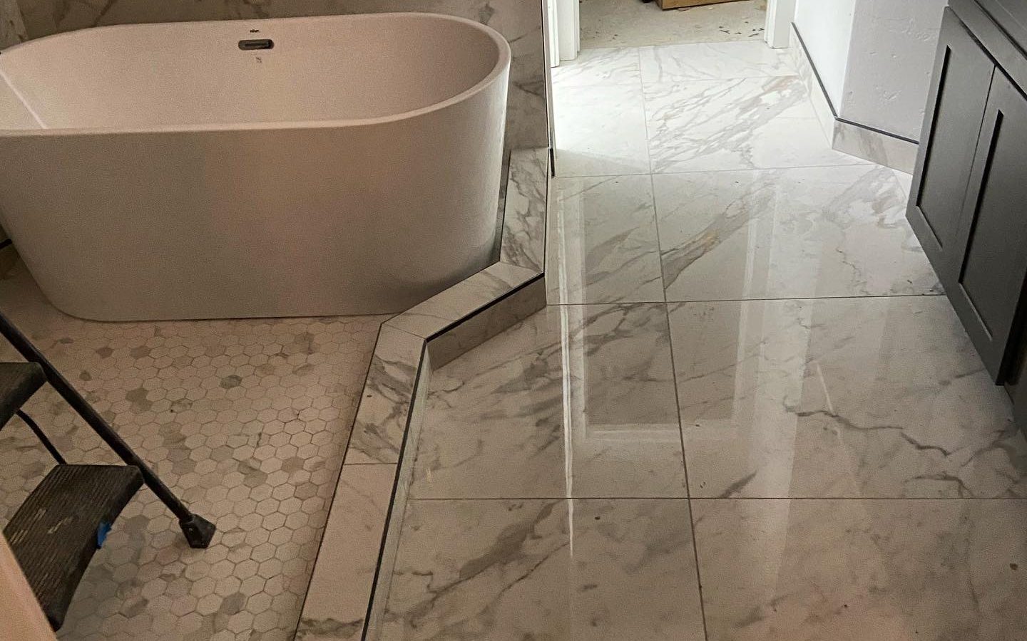 Freestanding tub on a marble-look porcelain floor
