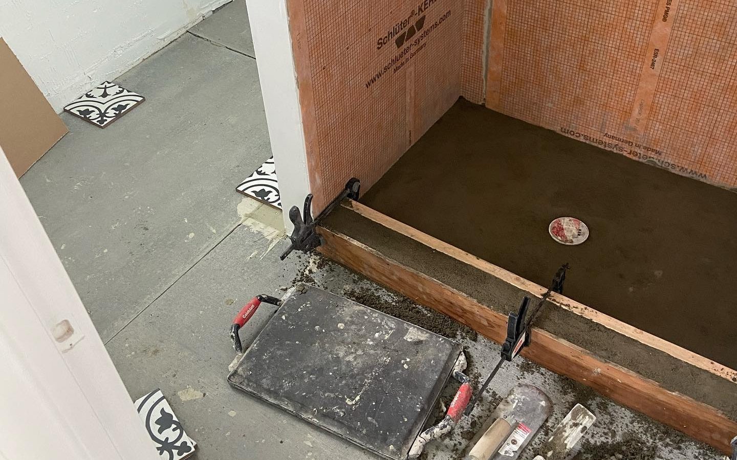 Shower stripped to the framing and pan before rebuild